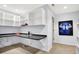 Bright home office boasts a large countertop work space, overhead shelving, and neutral decor at 4843 Snowberry Bay Ct, Carmel, IN 46033