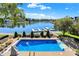 Overhead view of the refreshing in-ground pool, lake, and boat dock surrounded by lush greenery and a serene atmosphere at 4843 Snowberry Bay Ct, Carmel, IN 46033