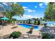 Backyard pool with beautiful lake view, surrounded by patio and greenery at 4843 Snowberry Bay Ct, Carmel, IN 46033