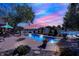 Inviting in-ground pool and patio area overlooking a serene lake at sunset at 4843 Snowberry Bay Ct, Carmel, IN 46033