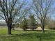 An expansive lawn dotted with mature trees provides shade and character to this picturesque backyard at 5210 S 100 E Rd, Anderson, IN 46013
