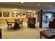 Finished basement showcasing a dining set, neutral carpeting, and decoratively adorned walls at 5210 S 100 E Rd, Anderson, IN 46013