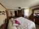 Comfortable bedroom with a ceiling fan, dresser, and a relaxing atmosphere at 5210 S 100 E Rd, Anderson, IN 46013