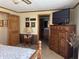 Relaxing bedroom with a ceiling fan, dresser, and a large television at 5210 S 100 E Rd, Anderson, IN 46013