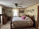 Serene bedroom with a ceiling fan, soft lighting, and a warm color palette at 5210 S 100 E Rd, Anderson, IN 46013