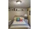 Bright bedroom with wallpaper, a brass bed frame, and a decorative shelf at 5210 S 100 E Rd, Anderson, IN 46013