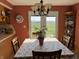 Bright dining area with french doors and a lush backyard view, featuring a hanging chandelier at 5210 S 100 E Rd, Anderson, IN 46013