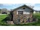 A stone-accented home featuring well-maintained landscaping and updated windows at 5210 S 100 E Rd, Anderson, IN 46013