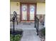 A welcoming front entrance with decorative glass doors, stone accents, and charming details at 5210 S 100 E Rd, Anderson, IN 46013