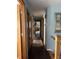 Hallway showing wood doors, framed artwork, and a glimpse into adjacent spaces at 5210 S 100 E Rd, Anderson, IN 46013