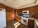 Kitchen featuring wooden cabinets, tile flooring, and modern white appliances at 5210 S 100 E Rd, Anderson, IN 46013