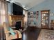 Comfortable living room featuring a wooden fireplace, hardwood floors, and large TV at 5210 S 100 E Rd, Anderson, IN 46013