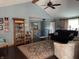 Bright living room with hardwood flooring, a glass cabinet, and a vaulted ceiling with wood beam at 5210 S 100 E Rd, Anderson, IN 46013