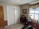 Home office with natural light, closet, wainscoting, and neutral carpet at 5210 S 100 E Rd, Anderson, IN 46013