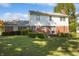 Spacious backyard with well-manicured hedges and a combination of brick and white siding on the home's exterior at 5363 Channing Rd, Indianapolis, IN 46226