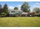 Traditional two-story home with brick and siding exterior, set on a well-kept lawn with mature trees creating a serene setting at 5363 Channing Rd, Indianapolis, IN 46226