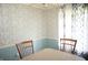 Charming dining area features patterned wallpaper, wainscoting, and a neutral tablecloth, exuding classic charm at 5363 Channing Rd, Indianapolis, IN 46226