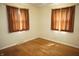 Cozy bedroom with hardwood floors, large windows, and a corner view, offering a simple, comfortable space at 5363 Channing Rd, Indianapolis, IN 46226