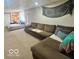 Carpeted basement featuring a seating area with a sofa, bed, and a decorative tapestry on the wall at 6036 Chinkapin Dr, Columbus, IN 47201