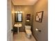 Well-lit powder room with pedestal sink, decorative mirror, and neutral paint at 6036 Chinkapin Dr, Columbus, IN 47201