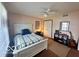 Cozy bedroom featuring a white bed frame, a ceiling fan, and a window offering natural light at 6036 Chinkapin Dr, Columbus, IN 47201