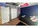This bedroom is decorated with dark blue walls and colorful decor, and has a closet for storage at 6036 Chinkapin Dr, Columbus, IN 47201