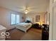 Cozy bedroom featuring a white bed frame, a ceiling fan, and a window offering natural light at 6036 Chinkapin Dr, Columbus, IN 47201