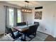 Cozy dining room with hardwood floors, modern lighting, and a large window at 6036 Chinkapin Dr, Columbus, IN 47201