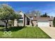 Charming two-story brick home featuring a well-manicured lawn and attached two car garage at 6036 Chinkapin Dr, Columbus, IN 47201