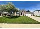 Charming front exterior of home with well manicured yard and driveway at 6036 Chinkapin Dr, Columbus, IN 47201