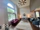 Bright living room with high ceilings, ceiling fan, large windows, and stylish furniture at 6036 Chinkapin Dr, Columbus, IN 47201