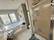 Bright main bathroom featuring a large soaking tub, separate shower, and honeycomb tile flooring at 6036 Chinkapin Dr, Columbus, IN 47201