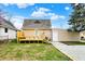 Cozy home featuring a new back deck, well-maintained lawn, and fresh gravel driveway at 604 Wood St, Greenfield, IN 46140