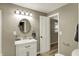 Well-lit bathroom features a sink, mirror, and a partially open door at 604 Wood St, Greenfield, IN 46140