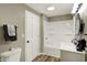 Clean bathroom features a white shower-tub combo and a vanity with a sink at 604 Wood St, Greenfield, IN 46140