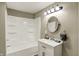 Bright bathroom showcasing a shower-tub combo with white wall paneling and a sink at 604 Wood St, Greenfield, IN 46140