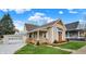 Charming bungalow featuring a welcoming front porch, well-manicured lawn, and a detached garage at 604 Wood St, Greenfield, IN 46140