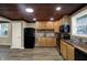 Open kitchen with stainless steel appliances, wood ceiling and counters, and a view to the dining area at 604 Wood St, Greenfield, IN 46140
