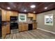 Kitchen with wooden cabinets, modern appliances, and new flooring at 604 Wood St, Greenfield, IN 46140