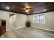 Living room with durable floors, wood ceiling, and bright window at 604 Wood St, Greenfield, IN 46140