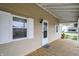 Inviting covered porch with wood flooring and white framed windows at 604 Wood St, Greenfield, IN 46140