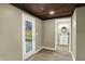 Room with a wood ceiling, a back door, and a doorway to a bathroom at 604 Wood St, Greenfield, IN 46140