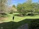 Landscaped backyard with well-maintained lawn, and decorative lighting at 6087 Boulder Ct, Columbus, IN 47201