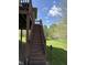 Exterior backyard steps lead to the upper deck and overlook a landscaped backyard at 6087 Boulder Ct, Columbus, IN 47201
