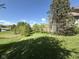 Beautiful, landscaped backyard featuring mature trees and a well-manicured lawn at 6087 Boulder Ct, Columbus, IN 47201