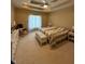 Cozy bedroom with a tray ceiling, ceiling fan, carpet, and a window with natural light at 6087 Boulder Ct, Columbus, IN 47201