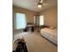 Comfortable bedroom with a window, ceiling fan, and two desks for study or work at 6087 Boulder Ct, Columbus, IN 47201