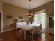 Elegant dining room featuring a chandelier, large windows, and a white dining set at 6087 Boulder Ct, Columbus, IN 47201