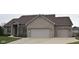 Charming brick home with a well-maintained lawn and a spacious two-car garage at 6087 Boulder Ct, Columbus, IN 47201