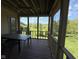 Screened patio with table and chairs overlooking beautiful lawn at 6087 Boulder Ct, Columbus, IN 47201